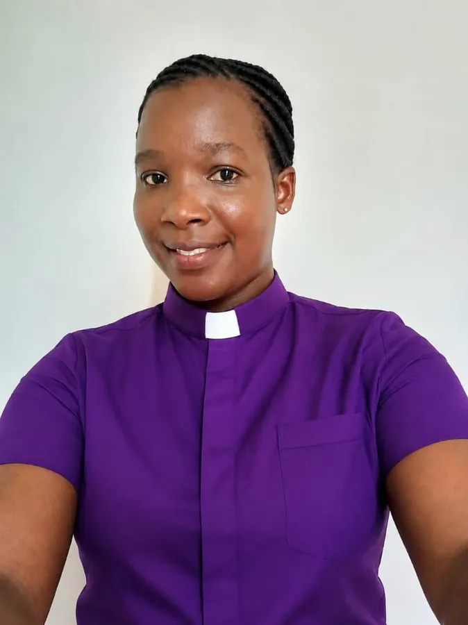First-cohort student in a purple clerical shirt