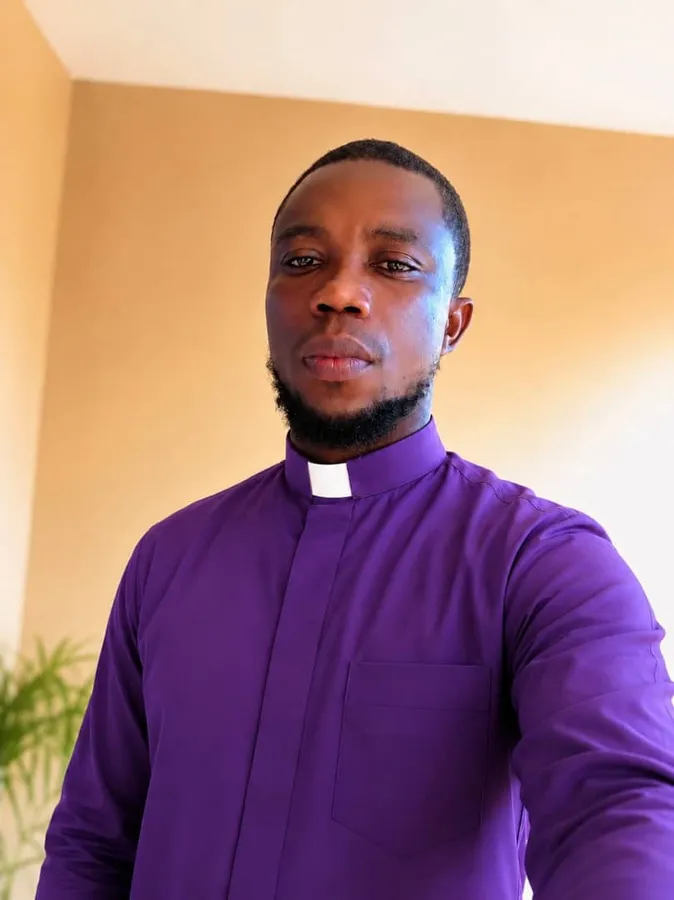 First-cohort student in purple clerical attire